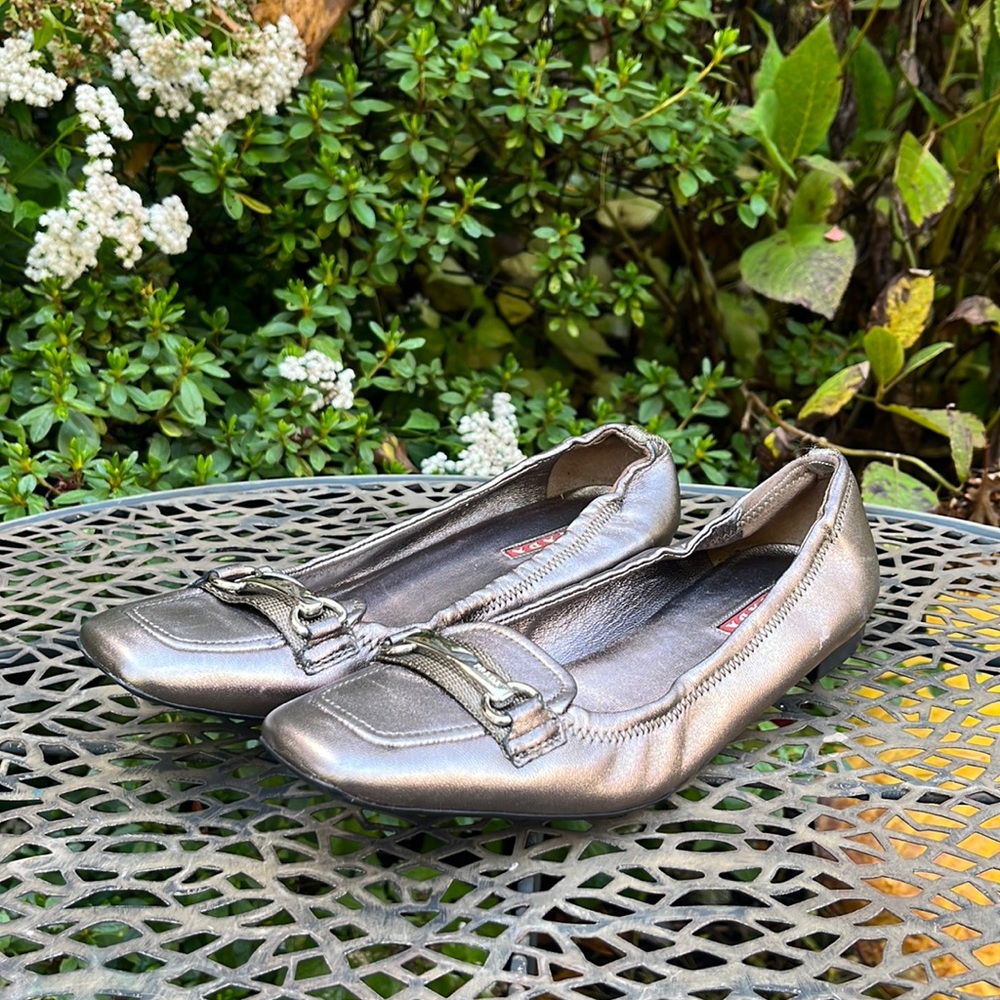 Prada metallic gunmetal leather size 35.5 flats with silver bar detail.